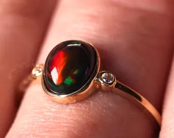 Celtic knot silver engagement ring featuring a genuine black fire opal stone with red play of color - natural opal ring tarnish resistant